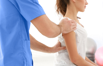 Chiropractor Helping Patient